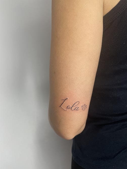 Tatuaje del nombre de un perro o mascota con una huella