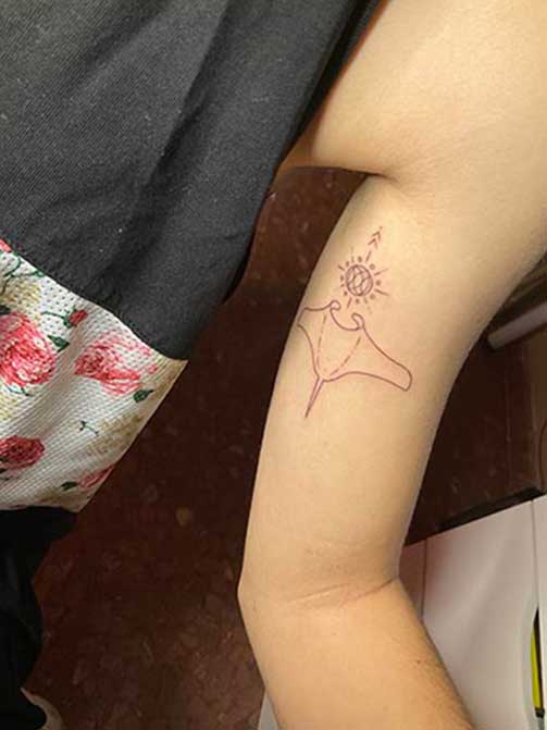 Tatuaje pequeño para mujer en el brazo estilo fineline de una mantaraya